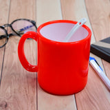 Colorful coffee mug with mixed design patterns.