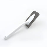 Versatile kitchen and bathroom cleaning brush with triangle design