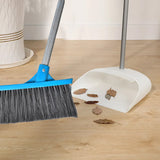 Floor scrub brush with long handle and stiff bristles for effective cleaning.