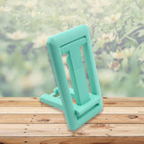 Mobile phone holder with adjustable height, foldable design