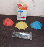 Colorful wall-mounted umbrella hooks, ideal for organizing keys and small items in bathrooms and kitchens.